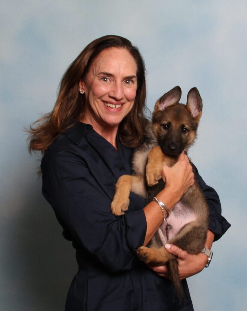 Karen Leies holding a German shepherd puppy.