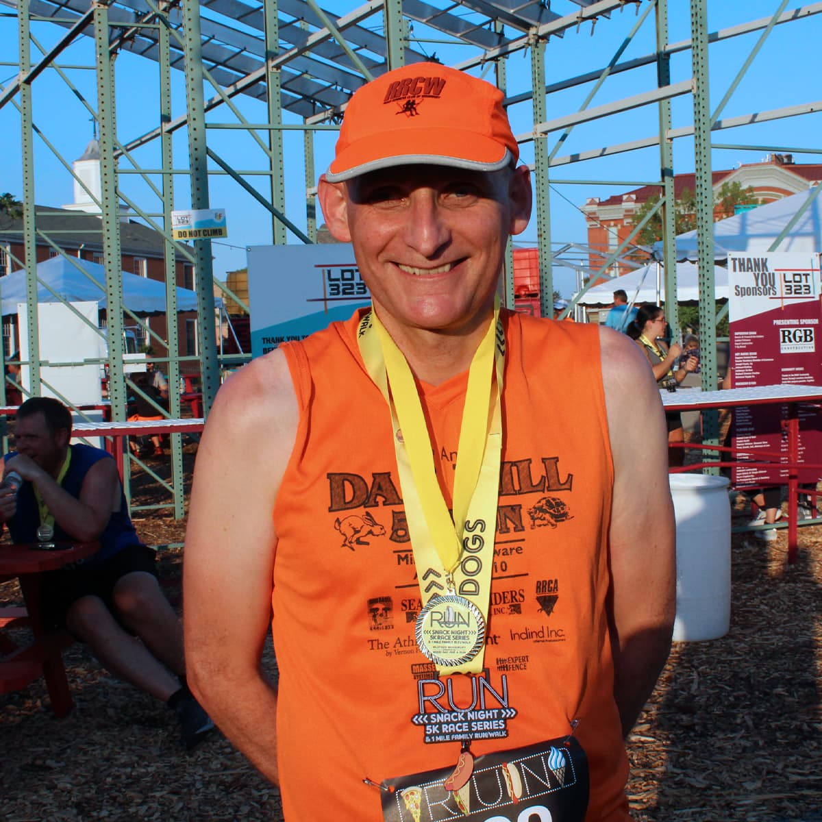 Seeing Eye graduate Ian smiles while wearing a medal for a 5K.