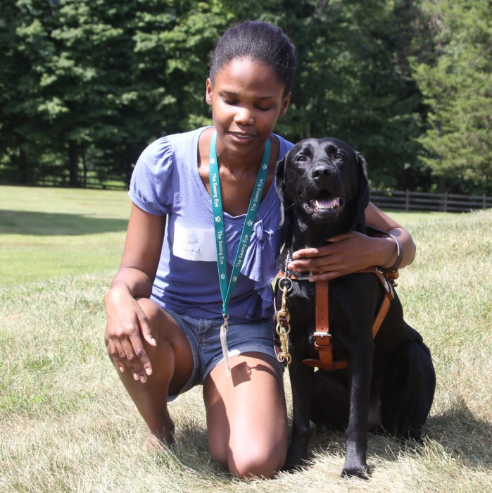 A Seeing Eye graduate with a black Labrador retriever.