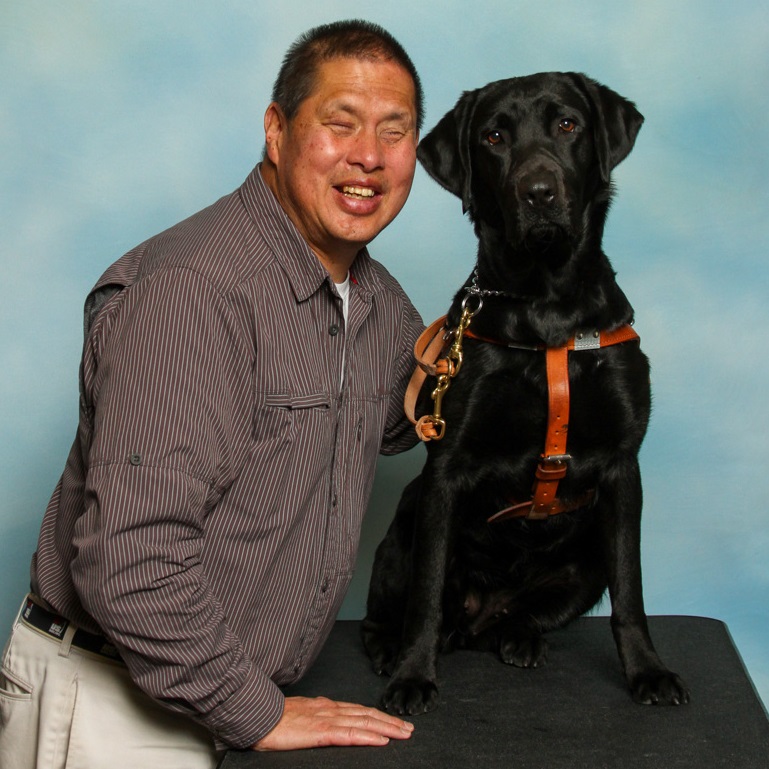 A Seeing Eye graduate with his Seeing Eye dog, a black Labrador/golden retriever cross.