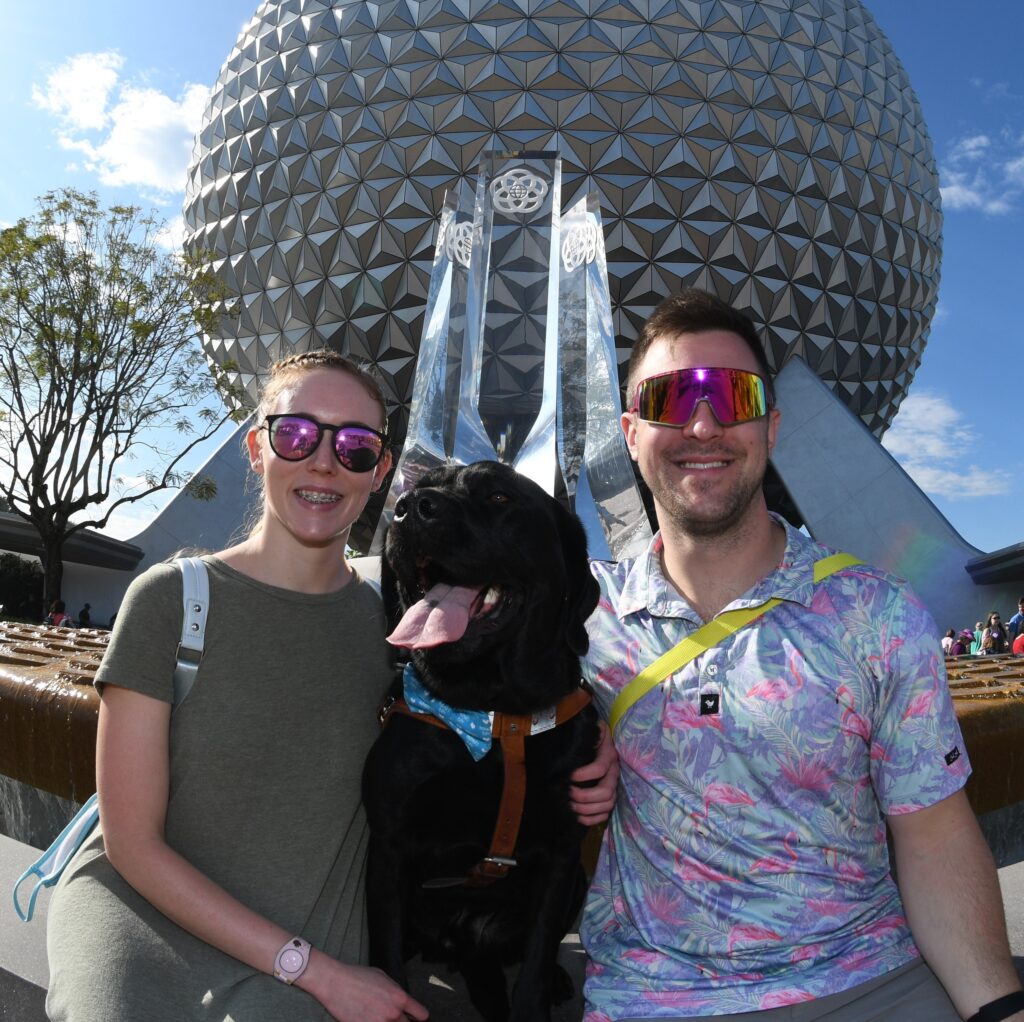 A graduate with her Seeing Eye dog at Disney World.