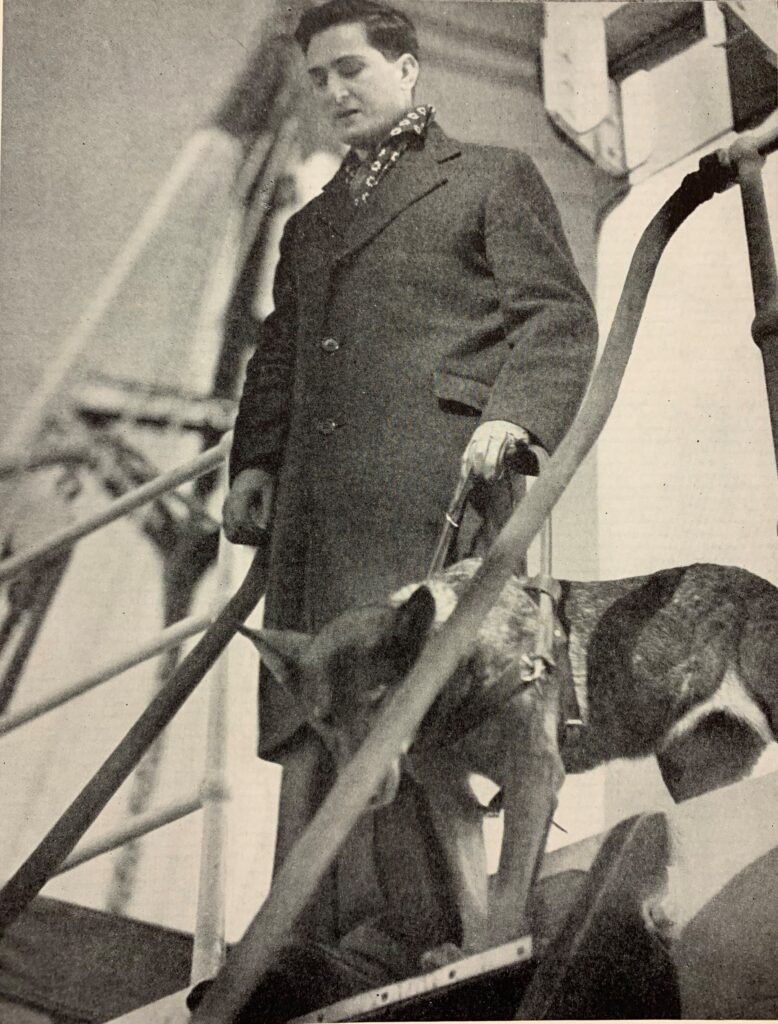 Morris Frank is guided off a ship by Buddy.