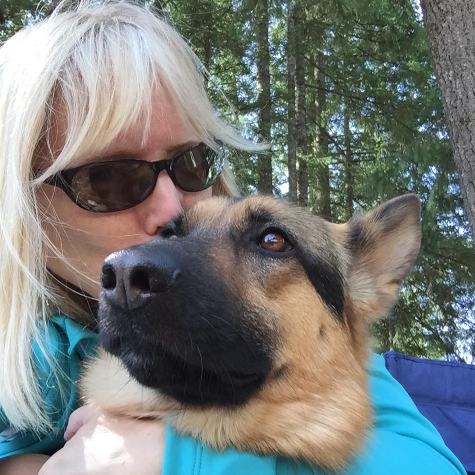 A Seeing Eye graduate hugs and kisses her Seeing Eye dog, a German shepherd.