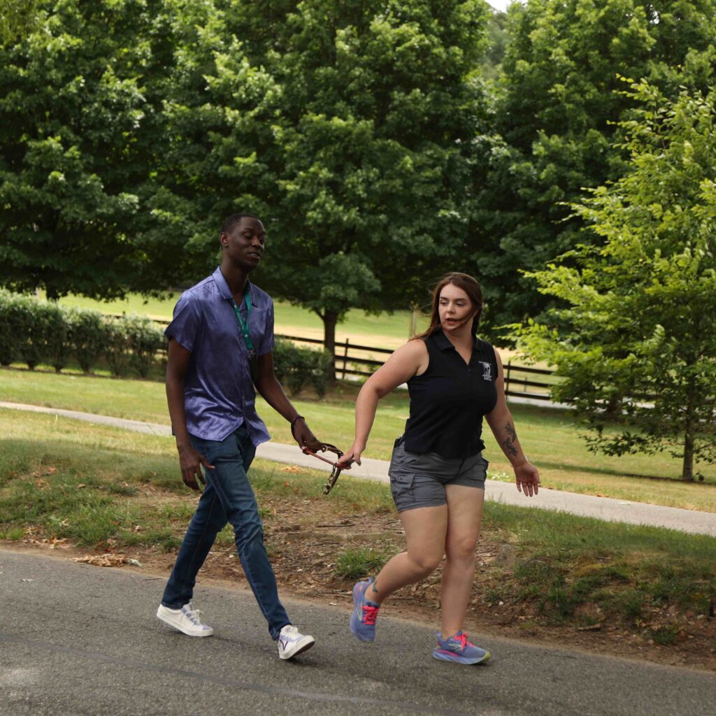 A student and instructor participate in a juno walk to gauge the student's natural pace and desired pull.