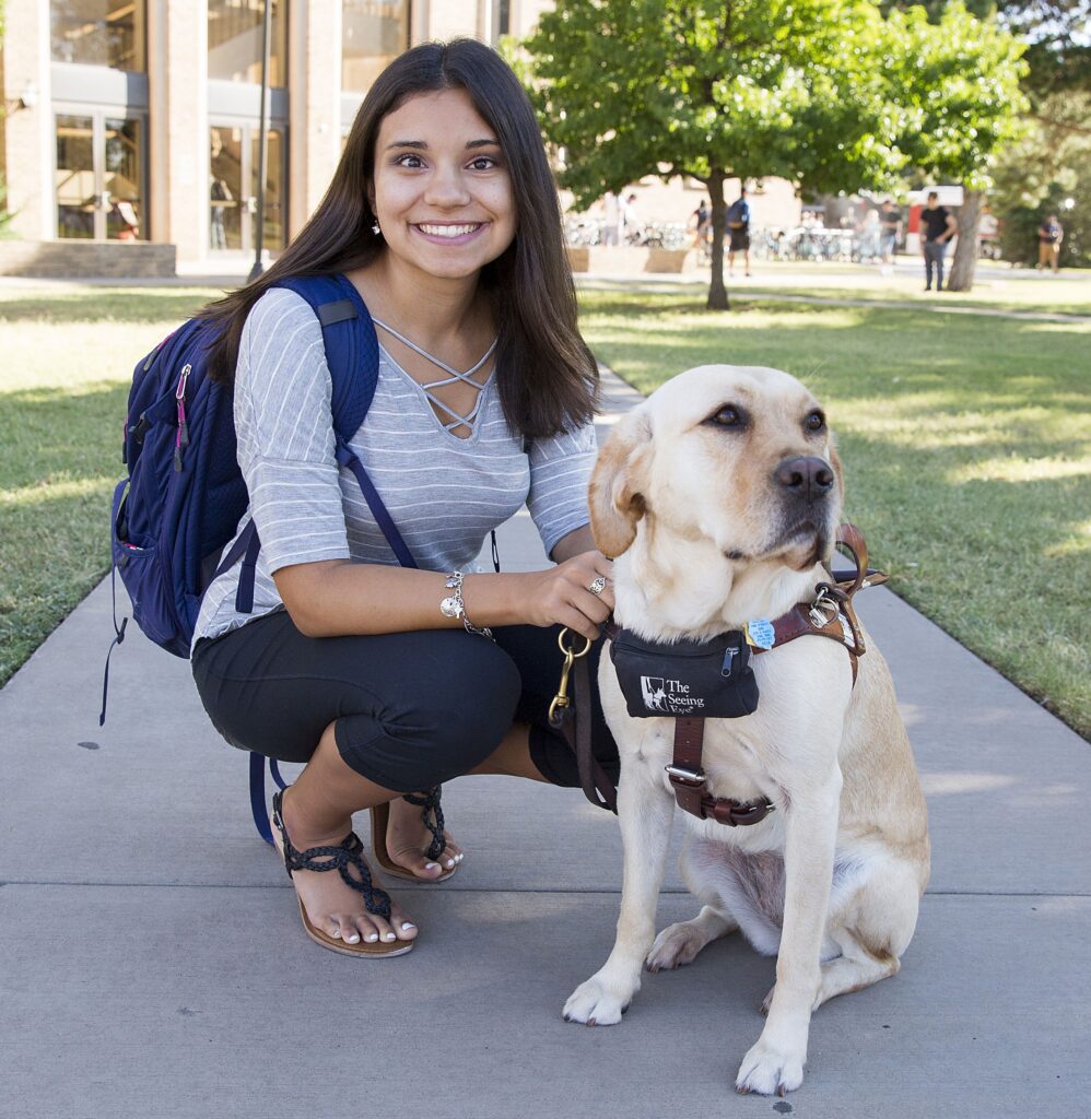 A Seeing Eye graduate with her Seeing Eye dog, a yellow Labrador retriever.