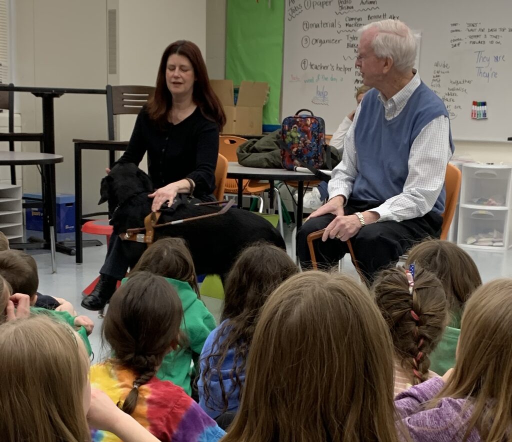 A Seeing Eye graduate and a Seeing Eye volunteer speak to a classroom of young children.