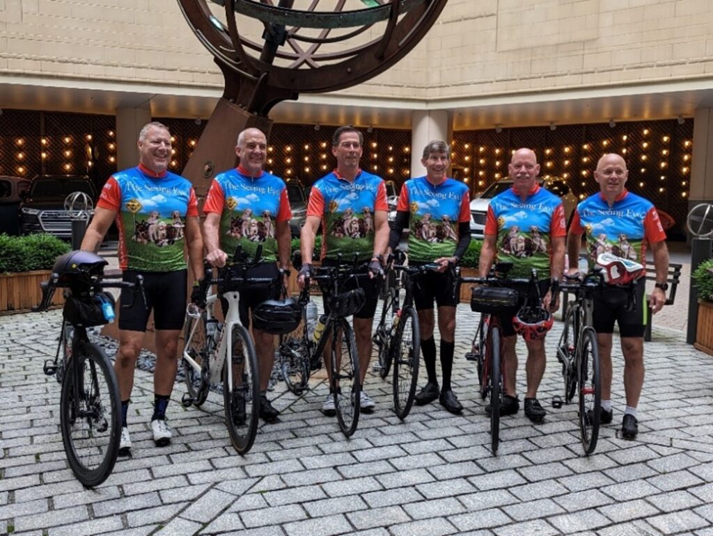 The six riders stand beside their bikes at the start of the ride in Boston, Massachusetts.