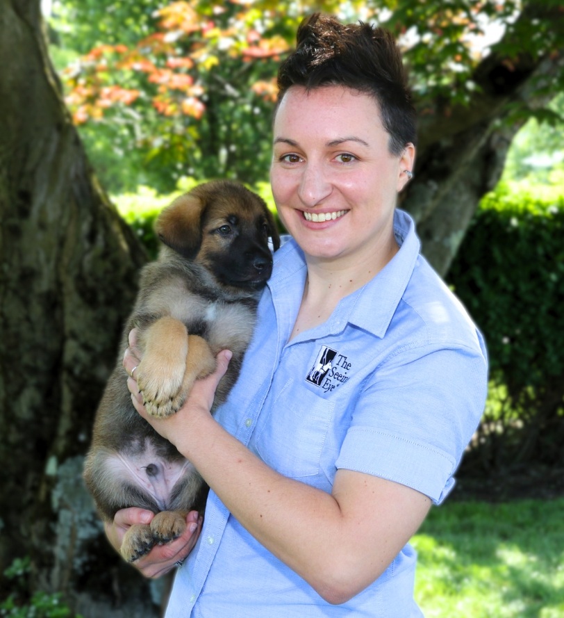 Lauren Christie holding a German shepherd puppy.