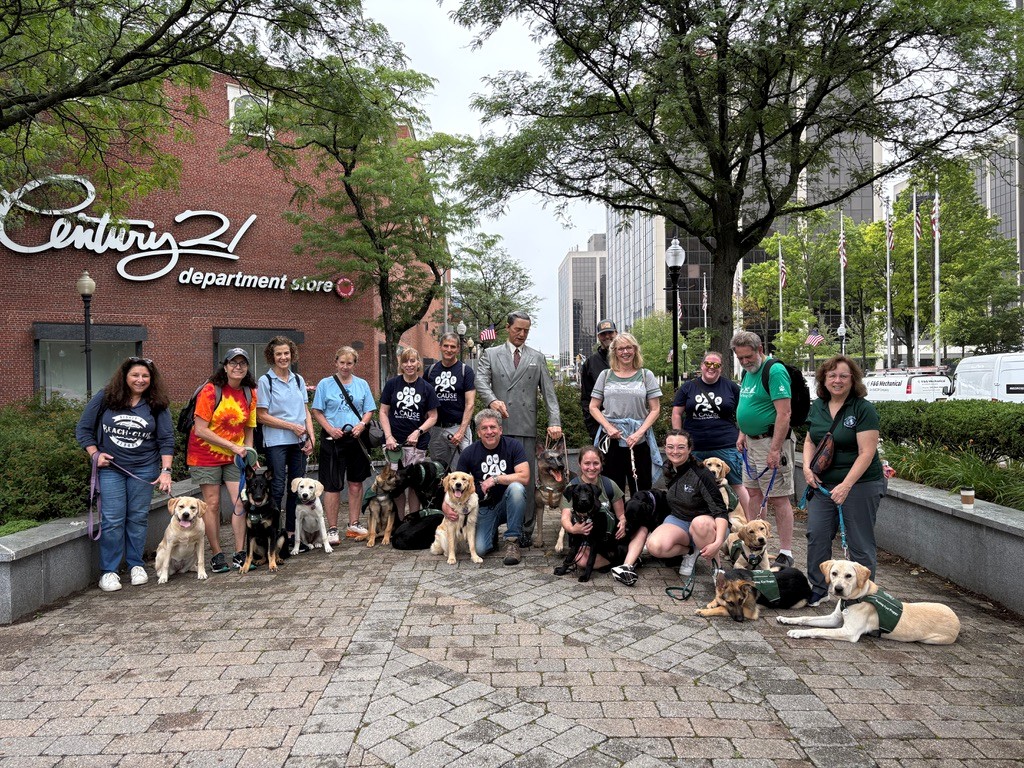 Members of the Morris County SW Seeing Eye puppy club stand together with their puppies by the Morris Frank & Buddy statue in Morristown.