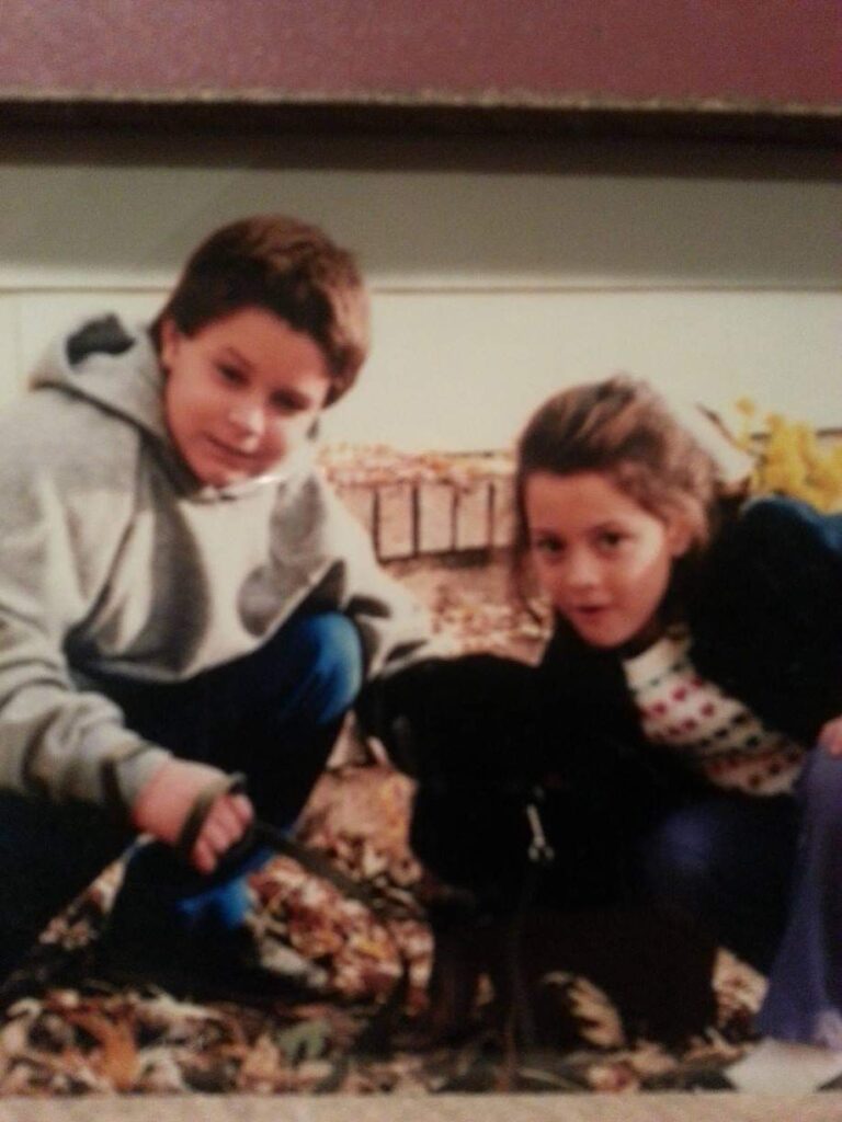 The young Whalen siblings with a black Lab Seeing Eye puppy they raised.