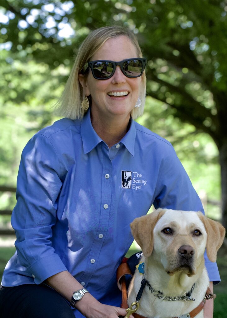 Seeing Eye graduate Melissa Allman, wearing Meta glasses, with her Seeing Eye dog, a yellow Labrador retriever named Aspen.