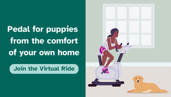 An image of a woman on a stationary bicycle while a yellow dog lies on the floor nearby. The text reads: 'Pedal for puppies from the comfort of your own home. Join the virtual ride.'
